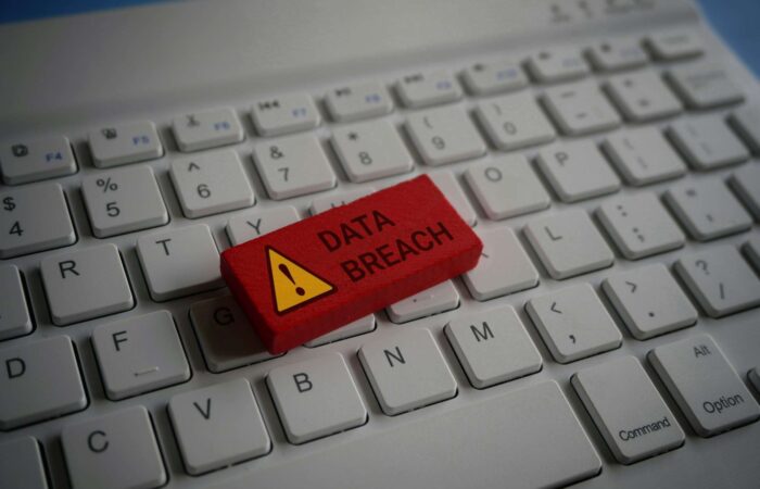 Close up image of computer keyboard and red wooden cube with text DATA BREACH.