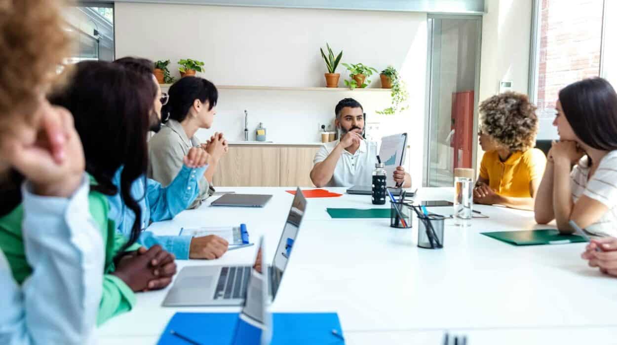 Multiracial employees listen to indian boss in company meeting. Copy space.